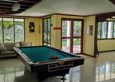Spacious recreational room with pool table and hardwood flooring