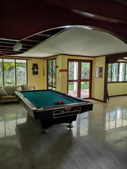 Spacious recreational room with pool table and hardwood flooring