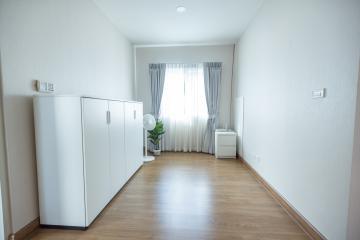 Bright and spacious bedroom with hardwood floors and minimalistic decor