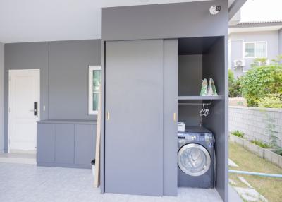 Modern home utility area with washing machine and storage space