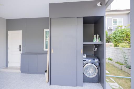 Modern home utility area with washing machine and storage space