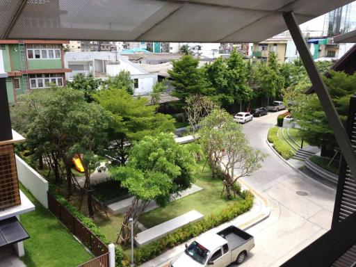 View of the residential area with greenery and street from a balcony