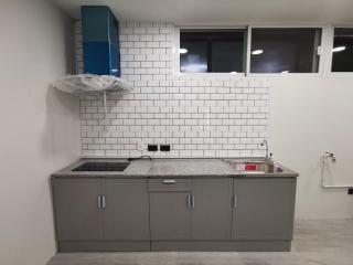 Modern kitchen with white subway tiles and gray cabinets