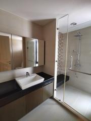 Modern bathroom interior with glass shower and large mirror