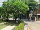 Lush greenery surrounding residential building entrance