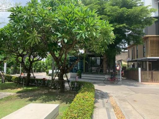 Lush greenery surrounding residential building entrance