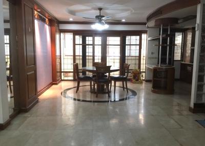 Spacious living room with dining area and ample natural lighting