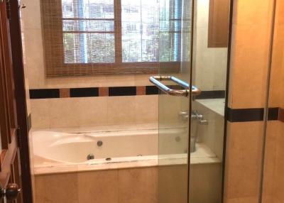 Spacious bathroom with tub and separate shower area