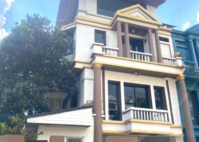 Modern three-story house with a clear blue sky in the background