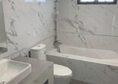 Modern bathroom with marble walls and sleek fixtures