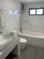 Modern bathroom with marble walls and sleek fixtures