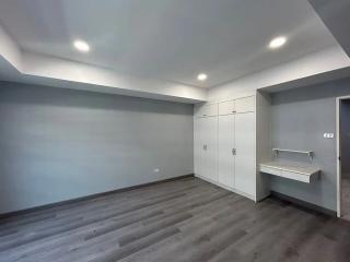 Spacious bedroom with built-in wardrobes and hardwood flooring