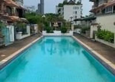 Outdoor swimming pool with surrounding residential buildings