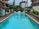 Outdoor swimming pool with surrounding residential buildings