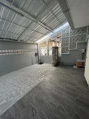 Spacious and well-lit indoor garage with tiled flooring