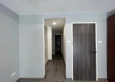 Modern hallway with wooden flooring and neutral wall colors