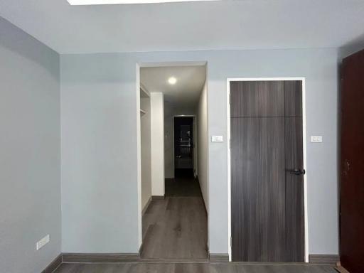 Modern hallway with wooden flooring and neutral wall colors