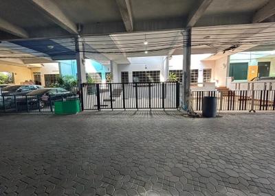 Paved parking space with a view of residential building entrance