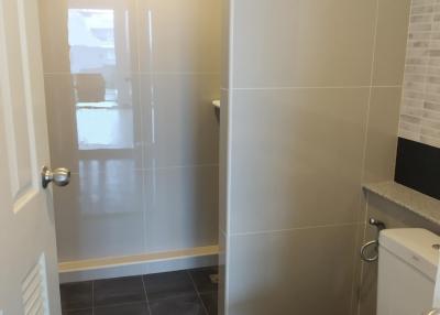 Modern bathroom interior with glass door shower and tiled walls