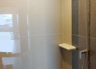 Modern bathroom shower area with wall tiles