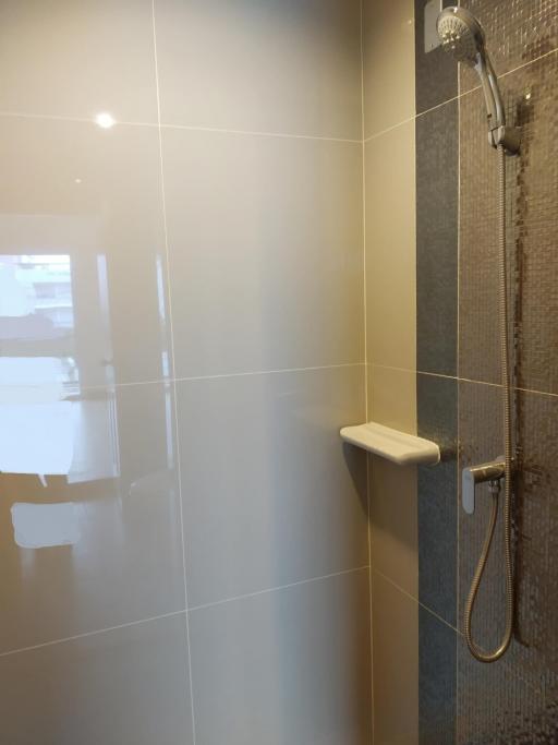 Modern bathroom shower area with wall tiles