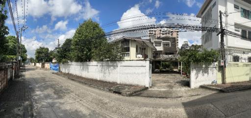 Residential house exterior with fenced yard and cloudy sky