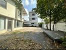 Spacious outdoor area of a residential building with parking space