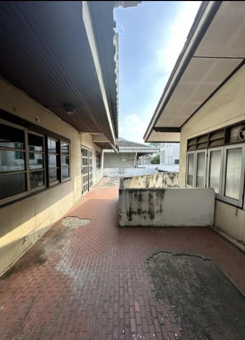 Brick-paved outdoor space with covered area near building structure