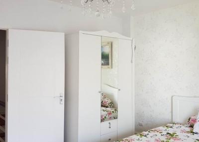 Elegant bedroom with floral bedding and a classic chandelier