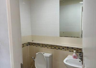 Compact bathroom with white tiling
