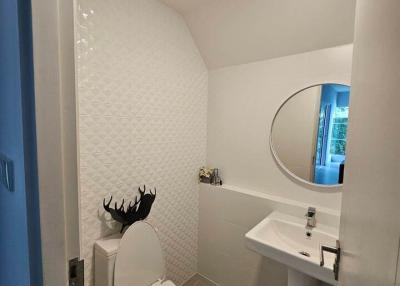 Modern bathroom with white tiles and wall-mounted sink