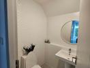 Modern bathroom with white tiles and wall-mounted sink