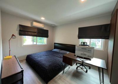 Cozy bedroom with queen-sized bed and modern furniture