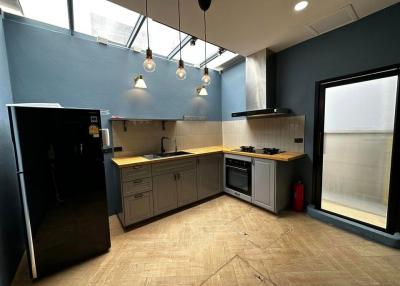 Modern kitchen with stainless steel appliances and blue walls