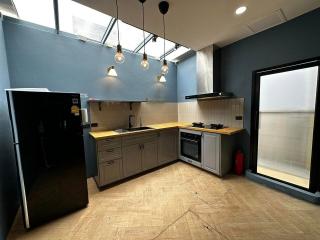 Modern kitchen with stainless steel appliances and blue walls