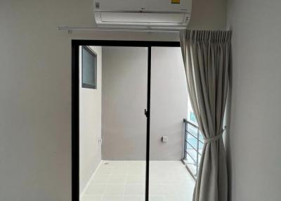 Spacious bedroom with air conditioning and balcony access