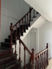 Elegant wooden staircase with black steps in a home