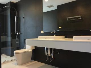 Modern bathroom interior with glass shower and double sink