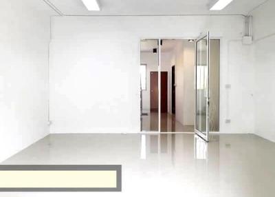 Spacious, well-lit empty room with glossy floor and white walls