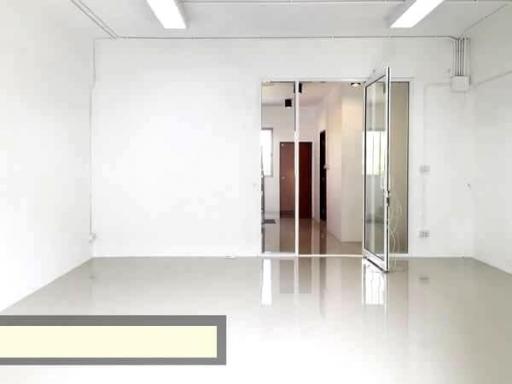 Spacious, well-lit empty room with glossy floor and white walls