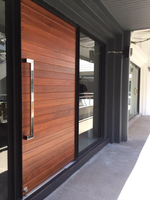 Modern exterior with large wooden door and glass windows