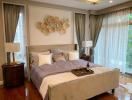 Elegant Master Bedroom with Natural Light and Modern Decor