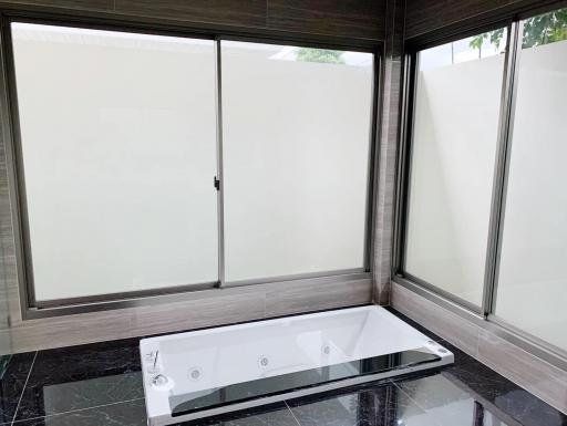 Modern bathroom with large bathtub and natural light