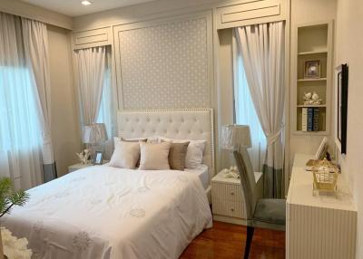 Elegant bedroom with white furnishings and hardwood floor