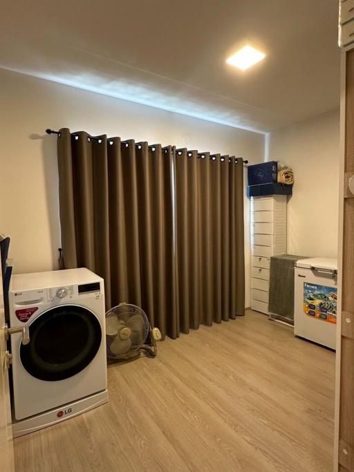 Compact utility room with washing machine and fridge