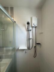 Modern bathroom with glass shower and wall-mounted water heater