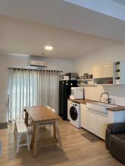 Modern kitchen with dining area and integrated appliances