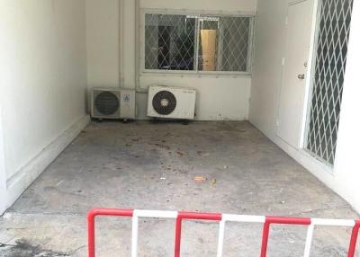 Empty interior space with air conditioning unit and security door