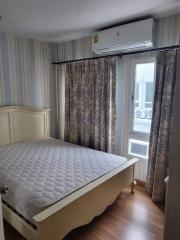 Cozy bedroom with air conditioning and patterned curtains