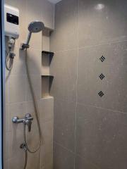 Modern bathroom with wall-mounted shower and built-in shelving